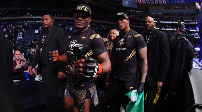 Nov 6, 2021; New York, NY, USA; Kamaru Usman (red gloves) leaves the octagon with his championship belt after defeating Colby Covington (blue gloves) during UFC 268 at Madison Square Garden.